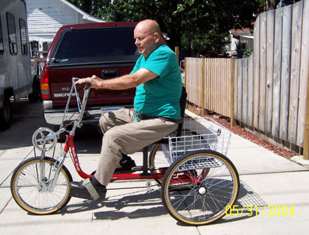 Photo of George Braden on three-wheeler